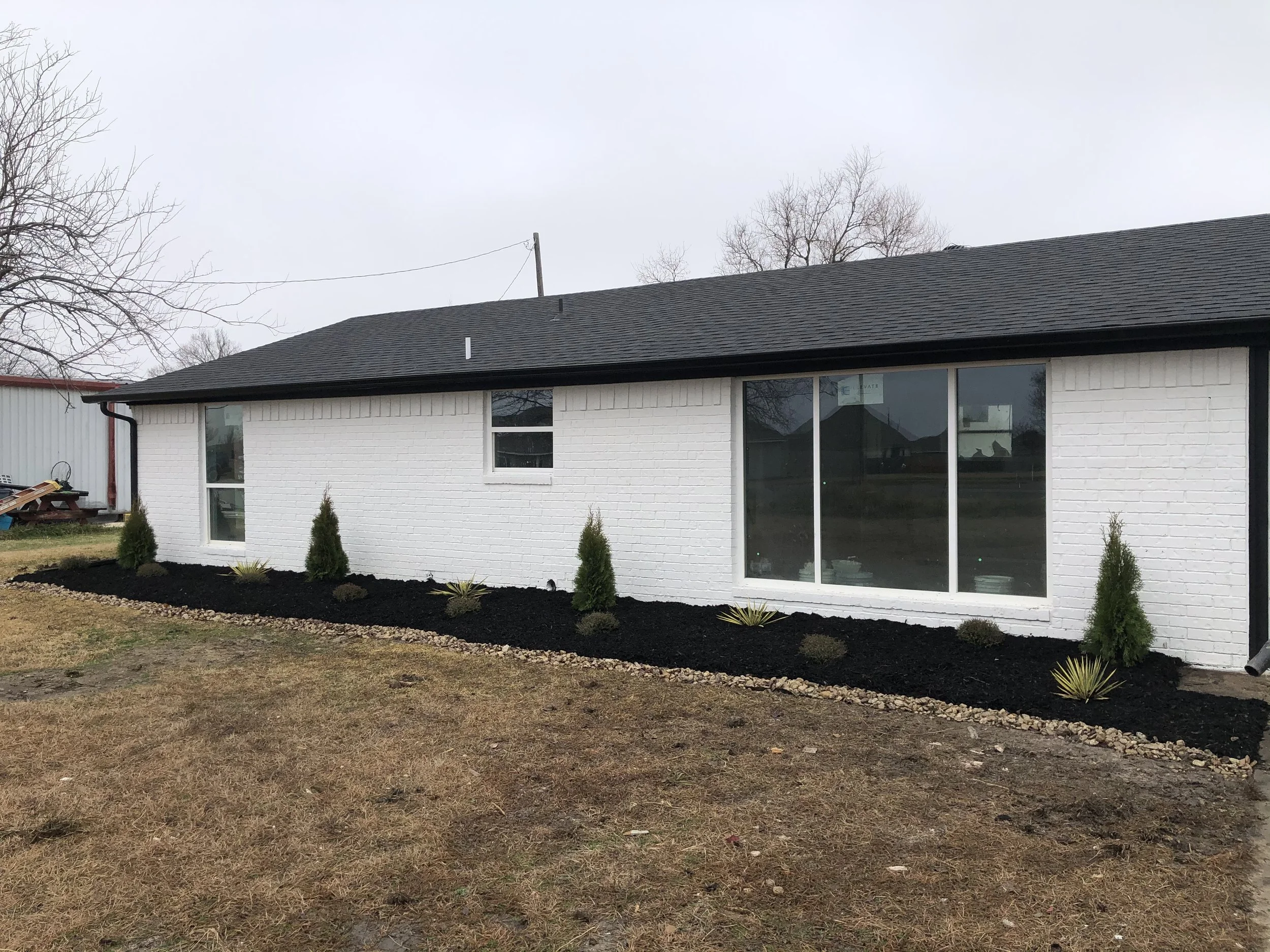 White brick house with fresh exterior paint and siding