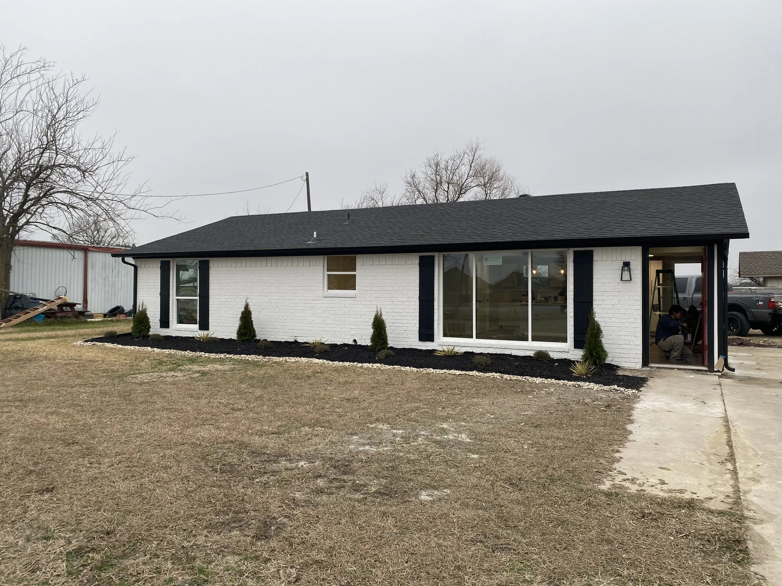 Renovated white brick home exterior by Golden Construction DFW