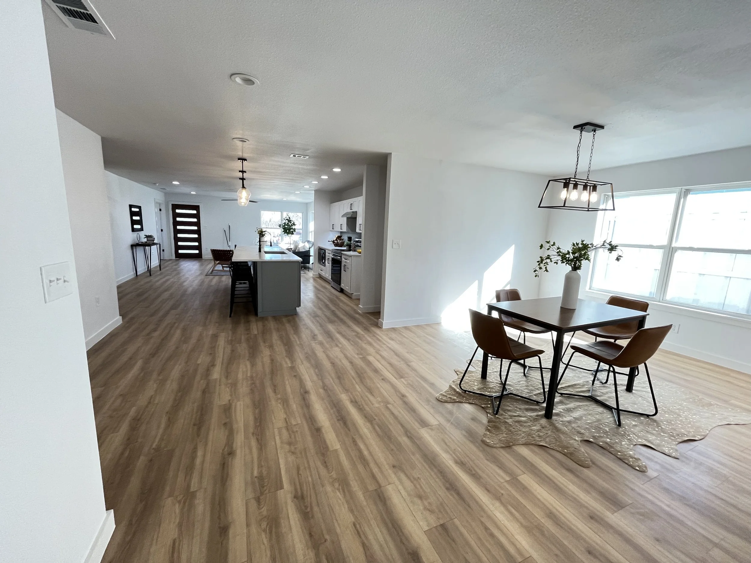 Kitchen and dining area with wood flooring and modern finishes